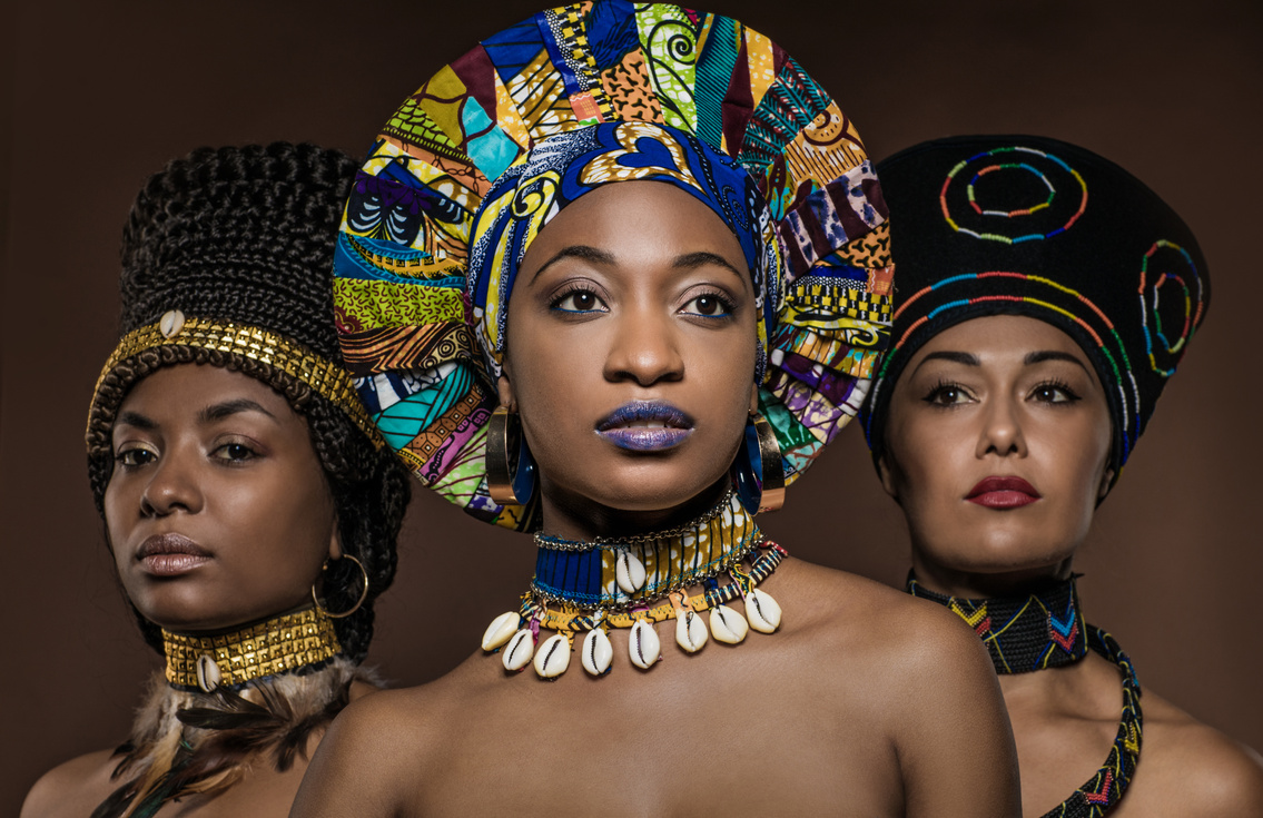 Three Beautiful Black Women wearing african headdresses