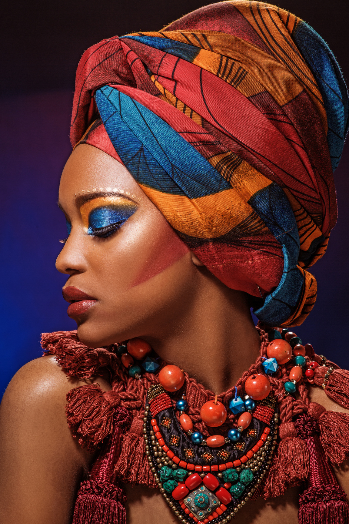 Beautiful Black Woman wearing african head wrap and jewellery